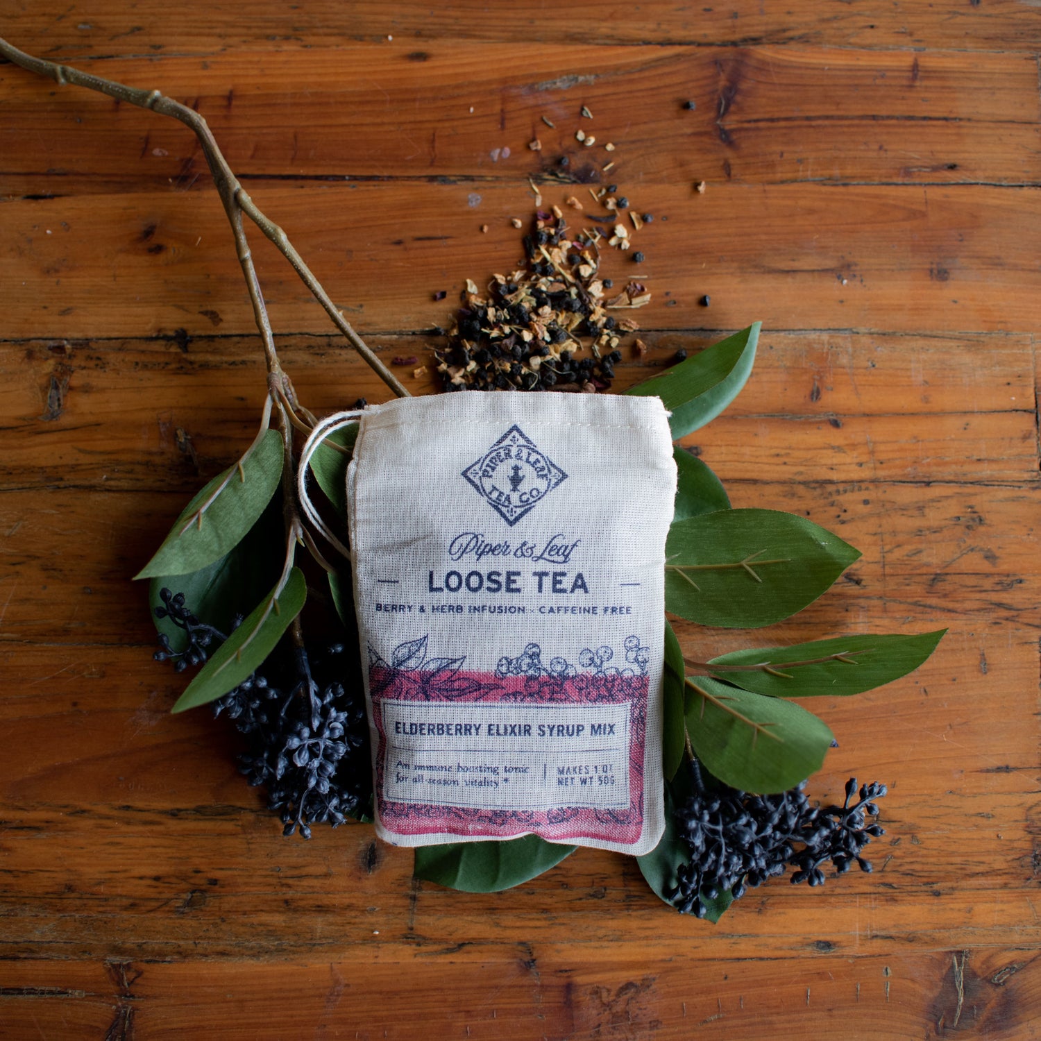 Bag of loose leaf tea Elderberry Elixir Syrup Mix on wooden table outside 