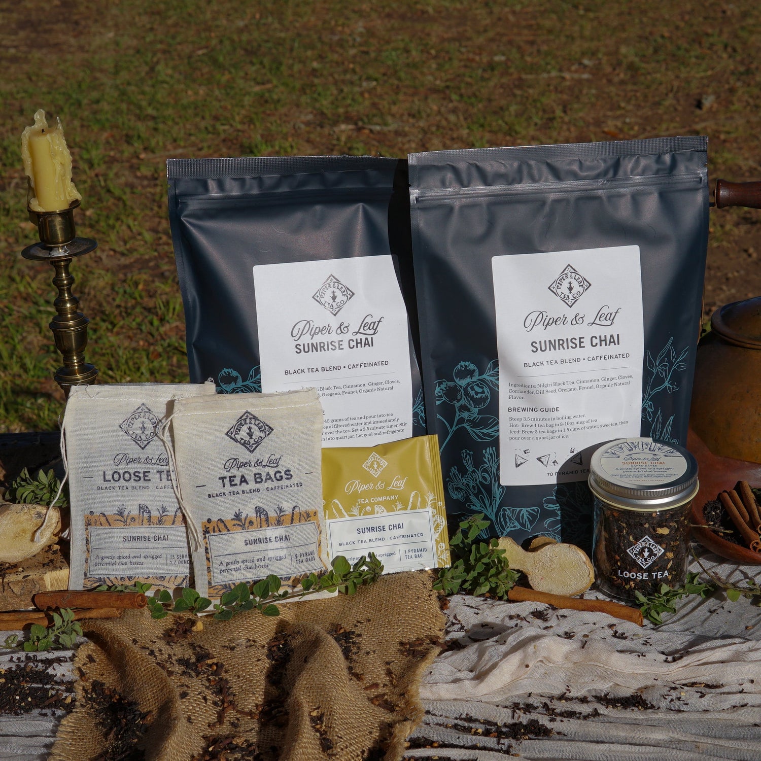 Dried herbs and loose leaf tea with a wooden spoon on a rustic table.