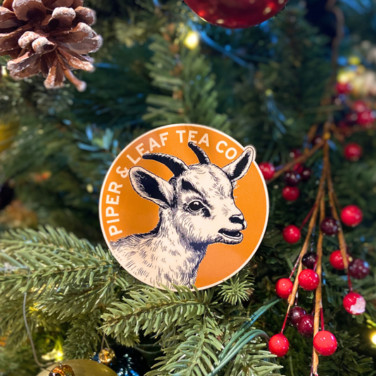 A Clyde the Goat sticker from Piper & Leaf Tea Co. adorns a Christmas tree.