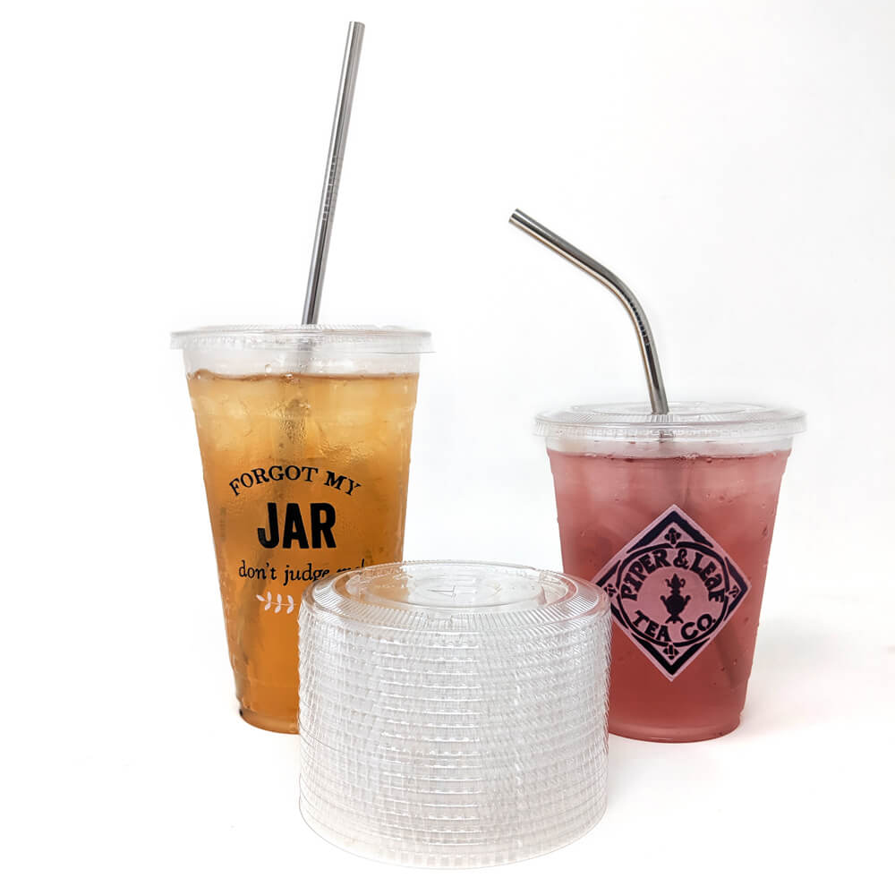 Two plastic cups with Piper & Leaf Tea Co. Stainless Steel Straws - 12 Pack (8.5") next to each other.